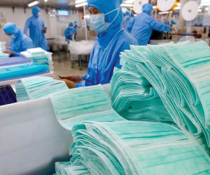 Photo: Stack of face masks at a factory